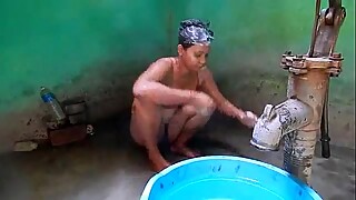 Indian house wife bathing front of her husband